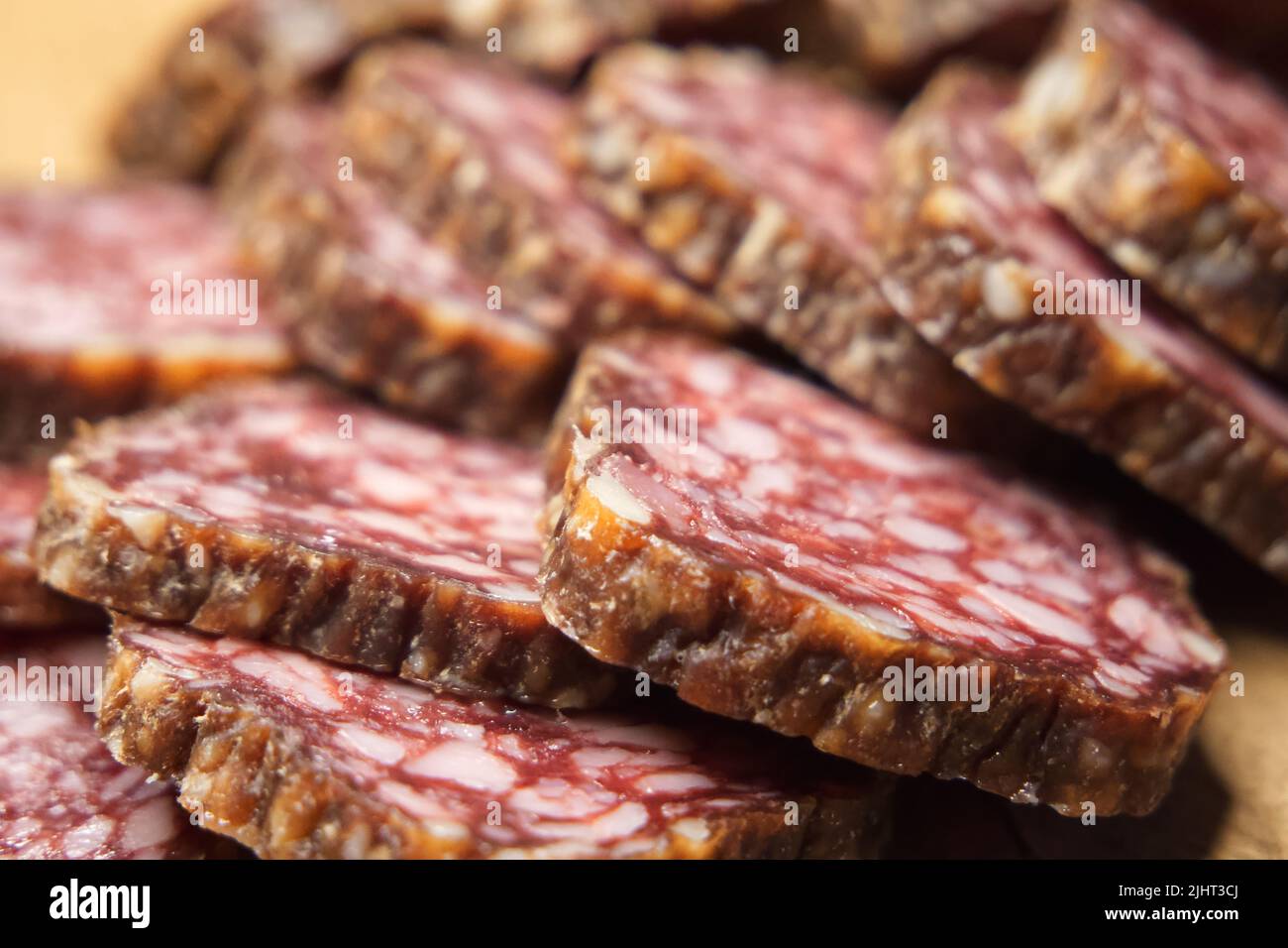 Chunks of dried sausage taken in closeup. Sausage full frame