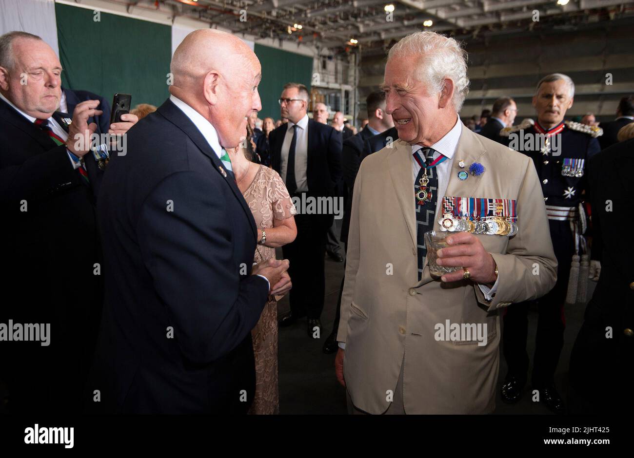 The Prince of Wales (right) talks to veterans of the Falklands war during a reception to mark the 40th anniversary of the conflict on board the Royal Navy aircraft carrier HMS Queen Elizabeth. Picture date: Wednesday July 20, 2022. Stock Photo