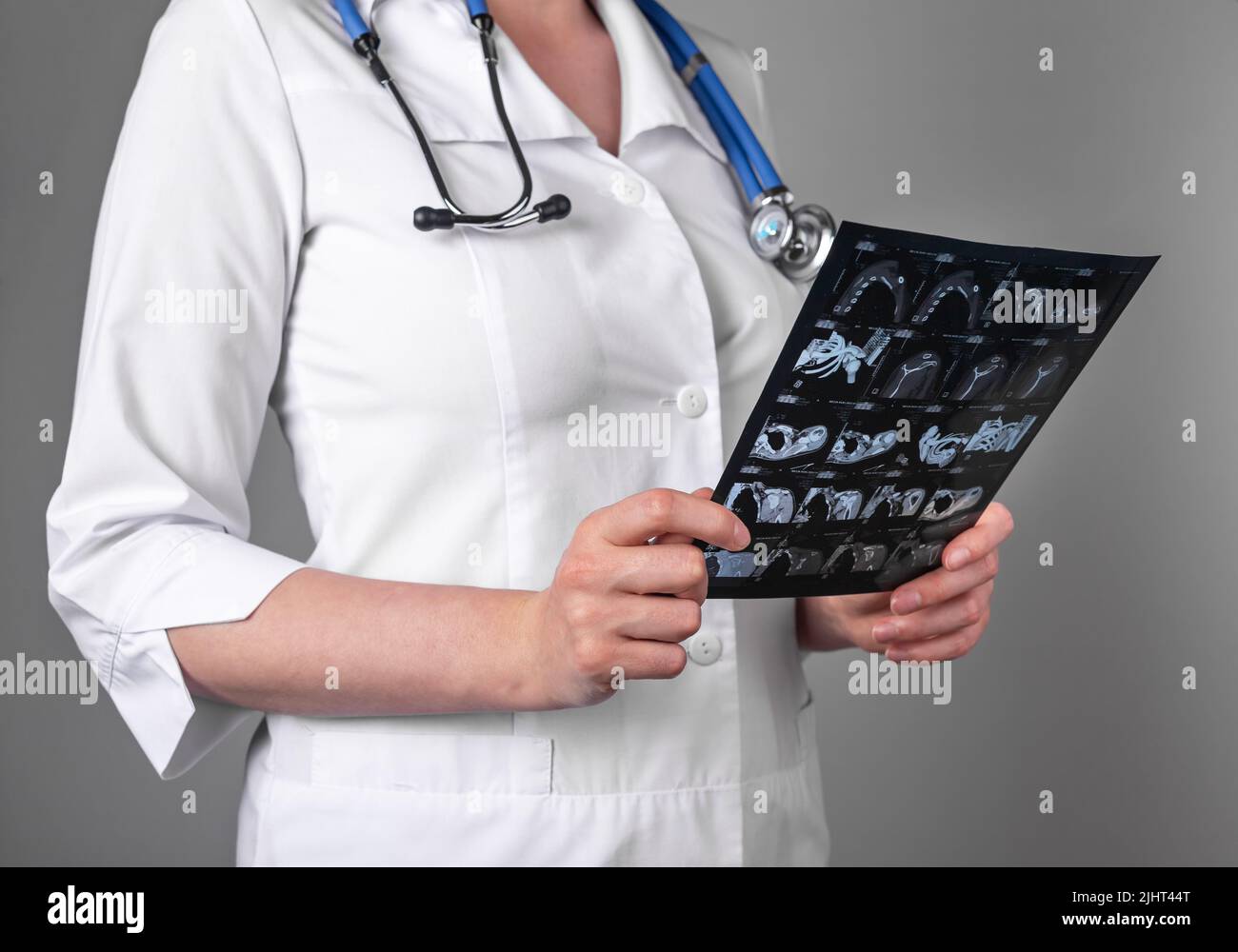 Doctor studying CT or MRI scan results. Diagnostics conducting for detecting diseases or injuries. Woman analyzing images of patient internal organs. Health care, medicine concept. High quality photo Stock Photo