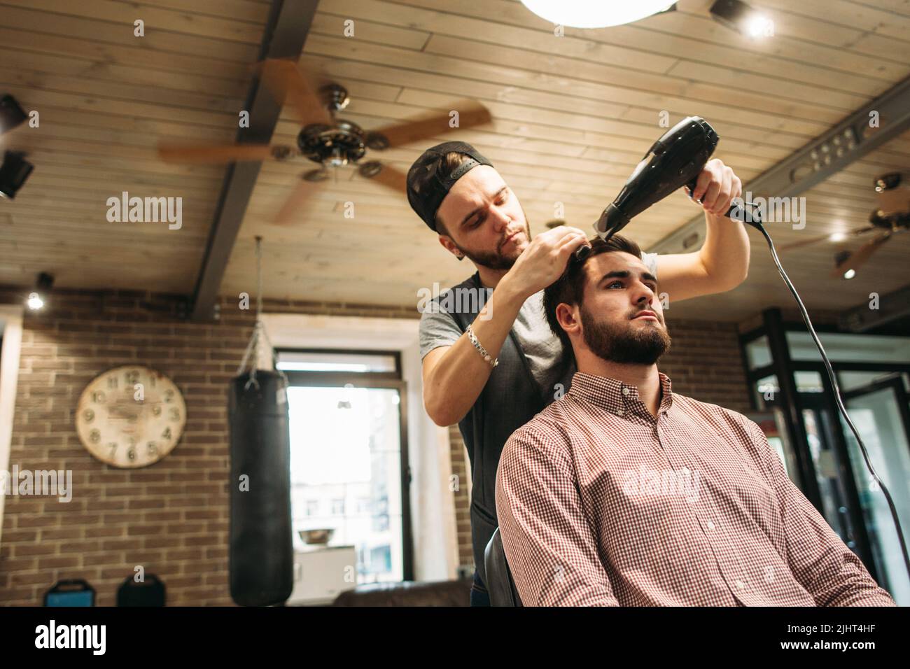 Hair stylist making haircut young hi-res stock photography and images ...