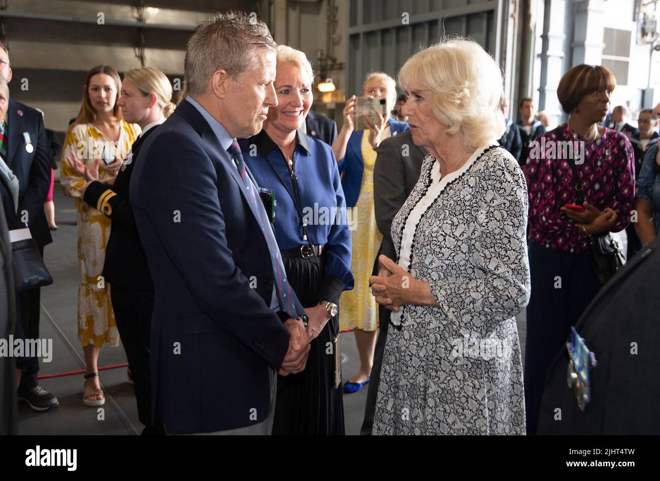 The Duchess of Cornwall (right) talks to guests during a reception to mark the 40th anniversary of the Falklands war on board the Royal Navy aircraft carrier HMS Queen Elizabeth. Picture date: Wednesday July 20, 2022. Stock Photo