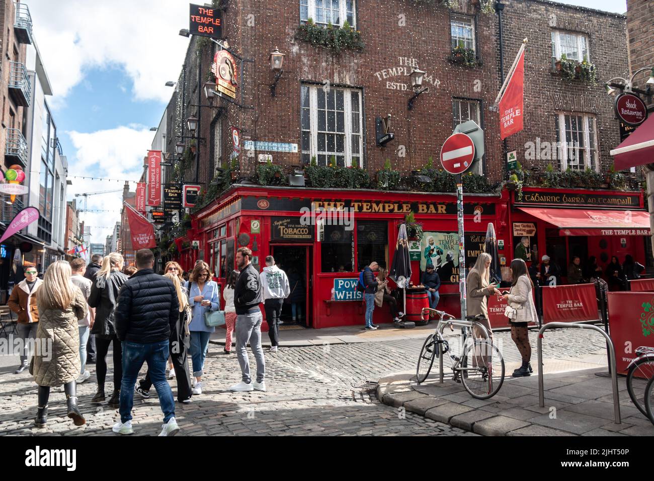 Dublin, Ireland - March 24, 2022: Crowds of tourists gather in Dublin's Temple Bar neighbourhood, a colourful downtown area of the city. Stock Photo