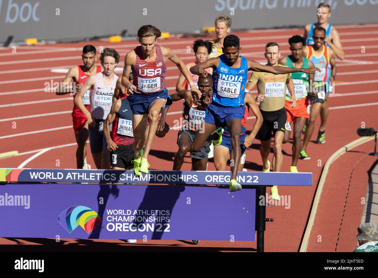 Evan Jager (USA) and Avinash Mukund Sable (IND) lead the pack as they jump the water barrier in the 3000 meter steeplechase during the afternoon sessi Stock Photo