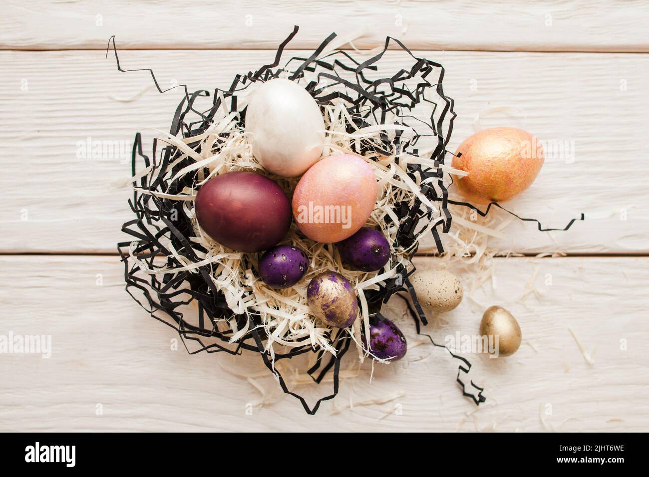 Easter background. Colorful eggs in the nest Stock Photo - Alamy