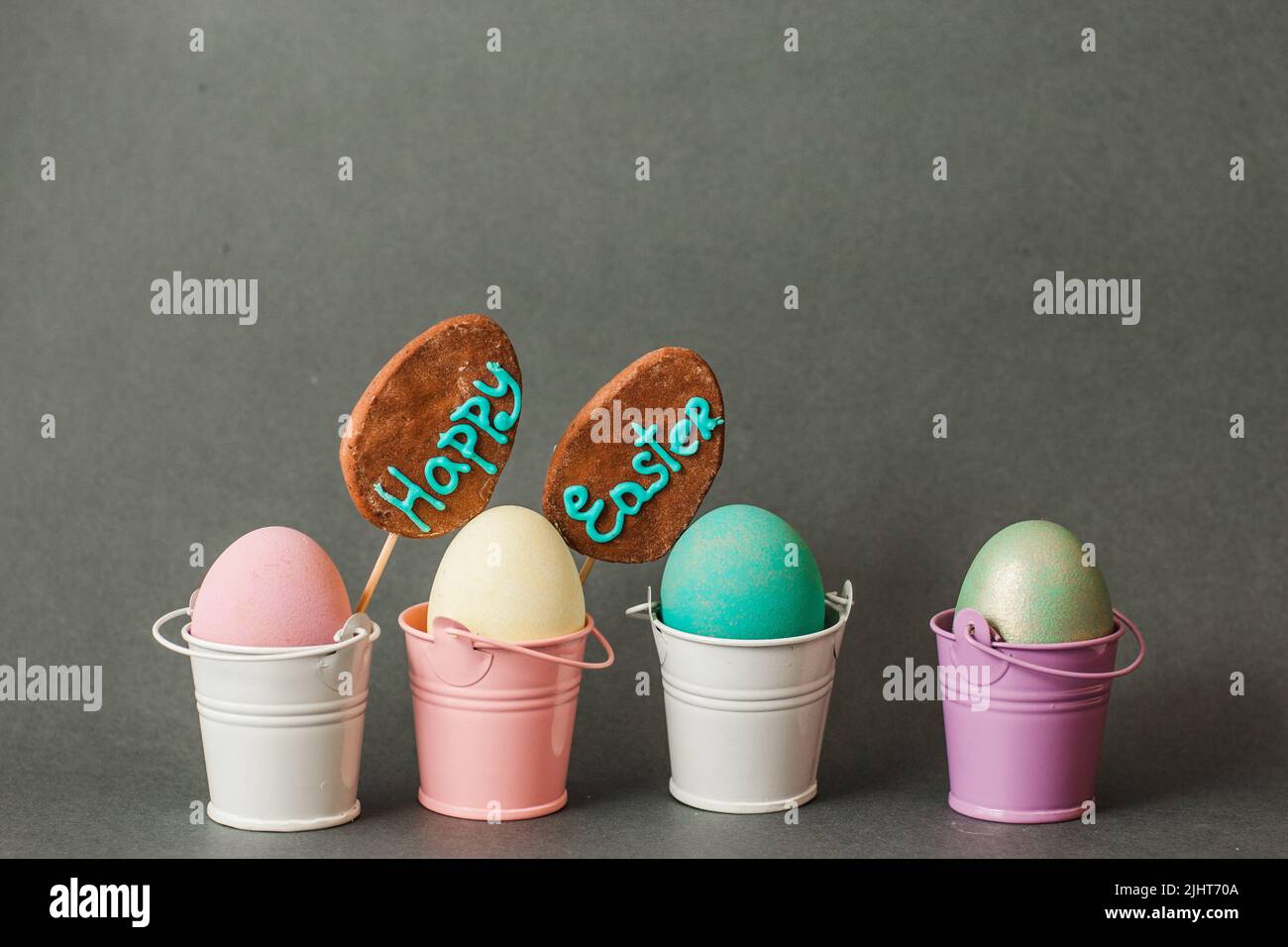 Color eggs in buckets. Happy easter background. Stock Photo
