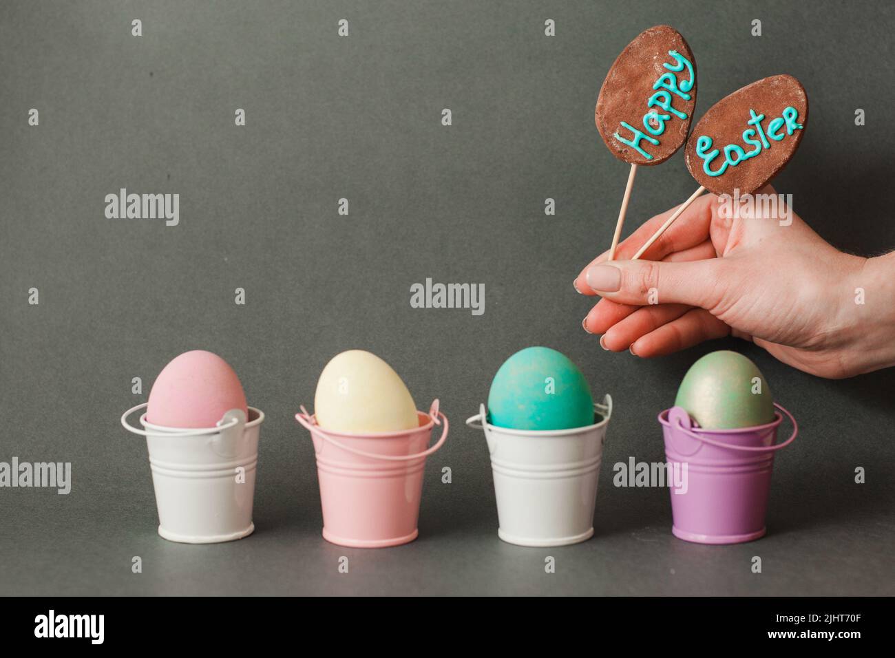 Color eggs in buckets. Happy easter background. Stock Photo