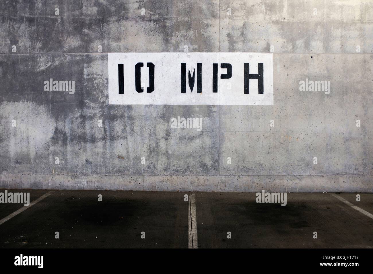 10 mph Speed Limit Sign painted on Wall of Parking Garage Stock Photo