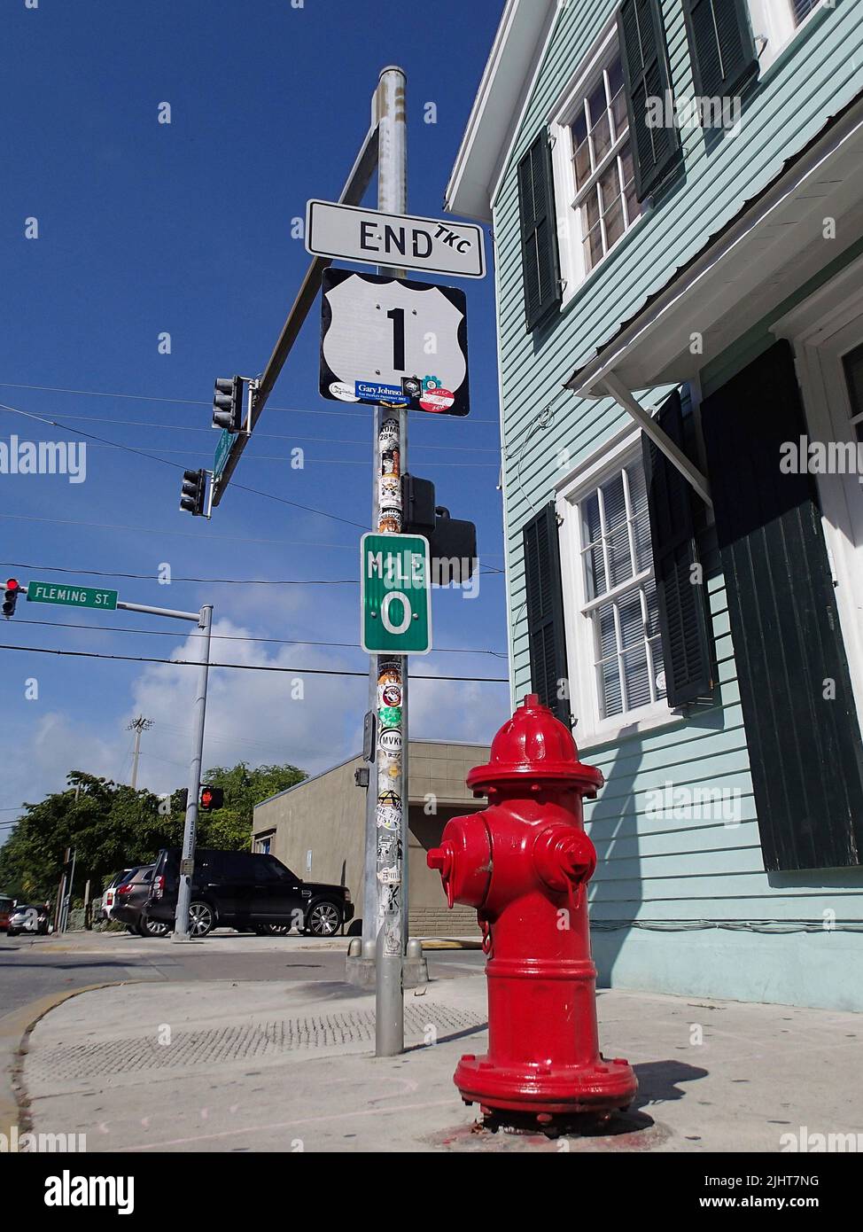 Key West, Florida, USA - 12 24 2012: red fire hydrant at ta cross of highway number 1 at Mile 0 Stock Photo