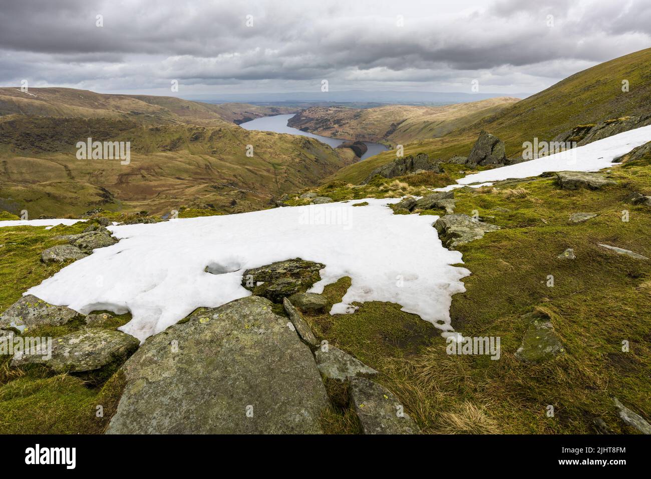 Small Water Tarn and Haweswater Reservoir from a snowy Harter Fell in late spring in the Lake District National Park, Cumbria, England. Stock Photo