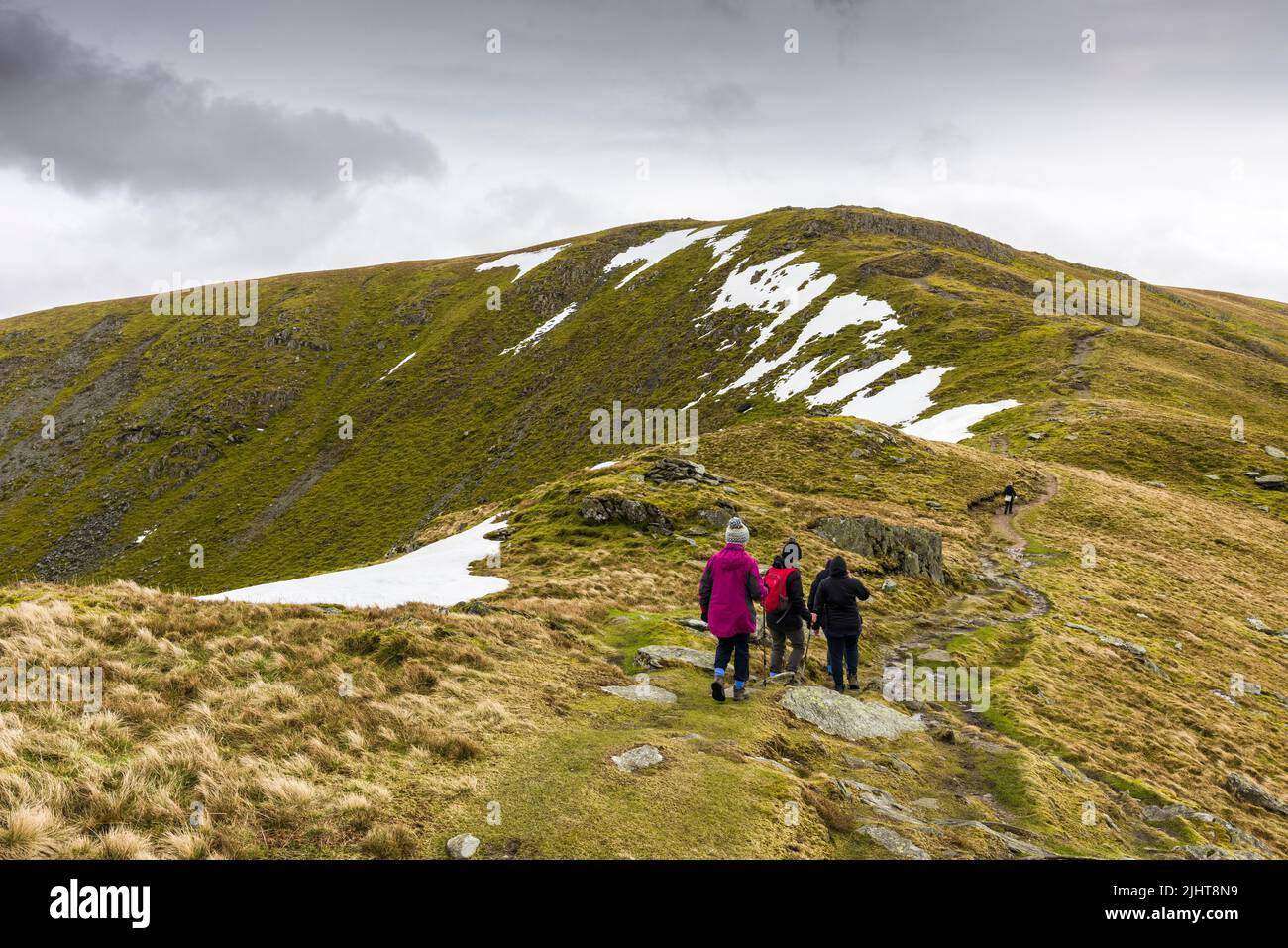 Walkers on Harter Fell on the footpath to the summit in late spring in the Lake District National Park, Cumbria, England. Stock Photo