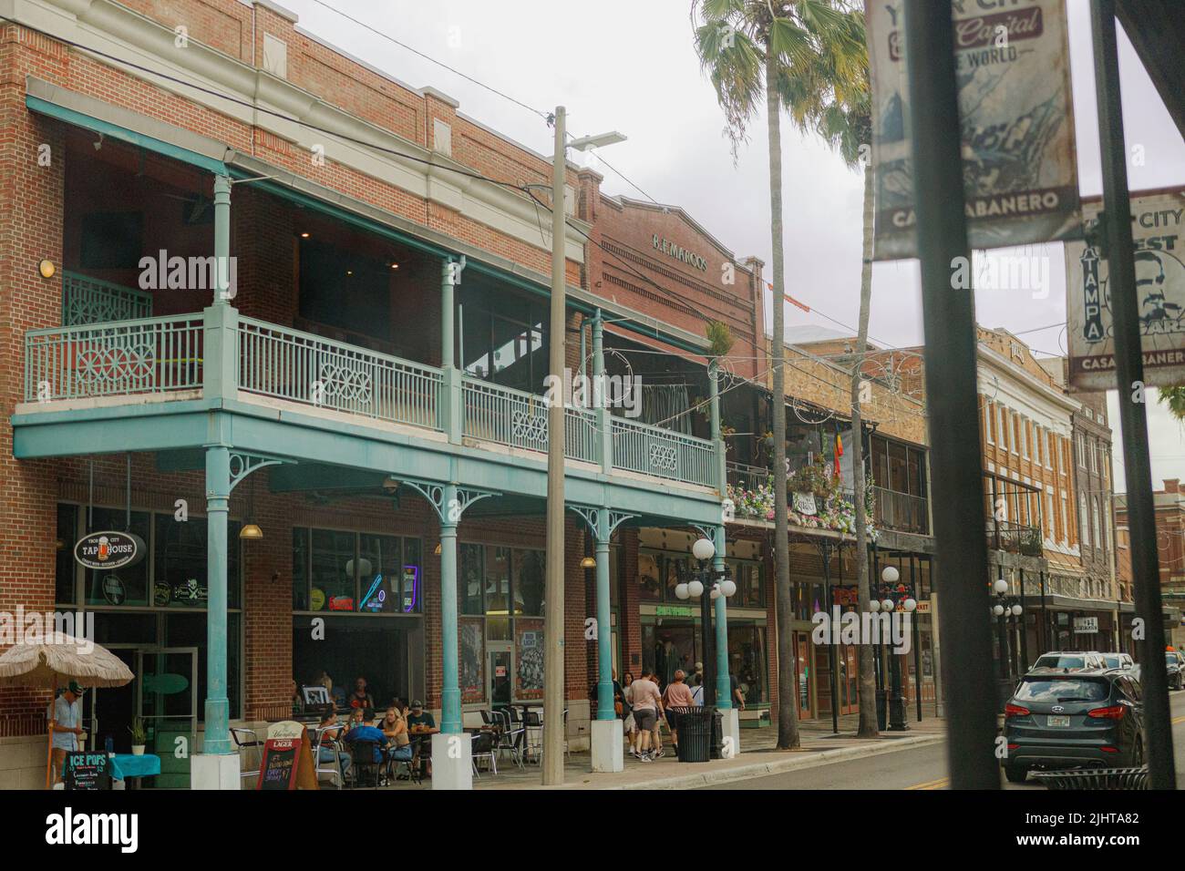 A group of people in an outdoor cafe on the street of the historic Ybor ...