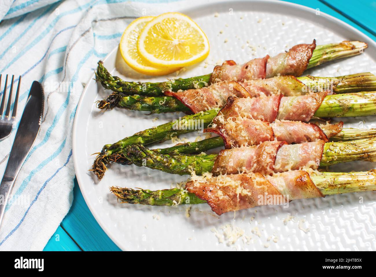 Grilled green asparagus wrapped with bacon. Ketogenic diet. Healthy food, diet menu. Stock Photo