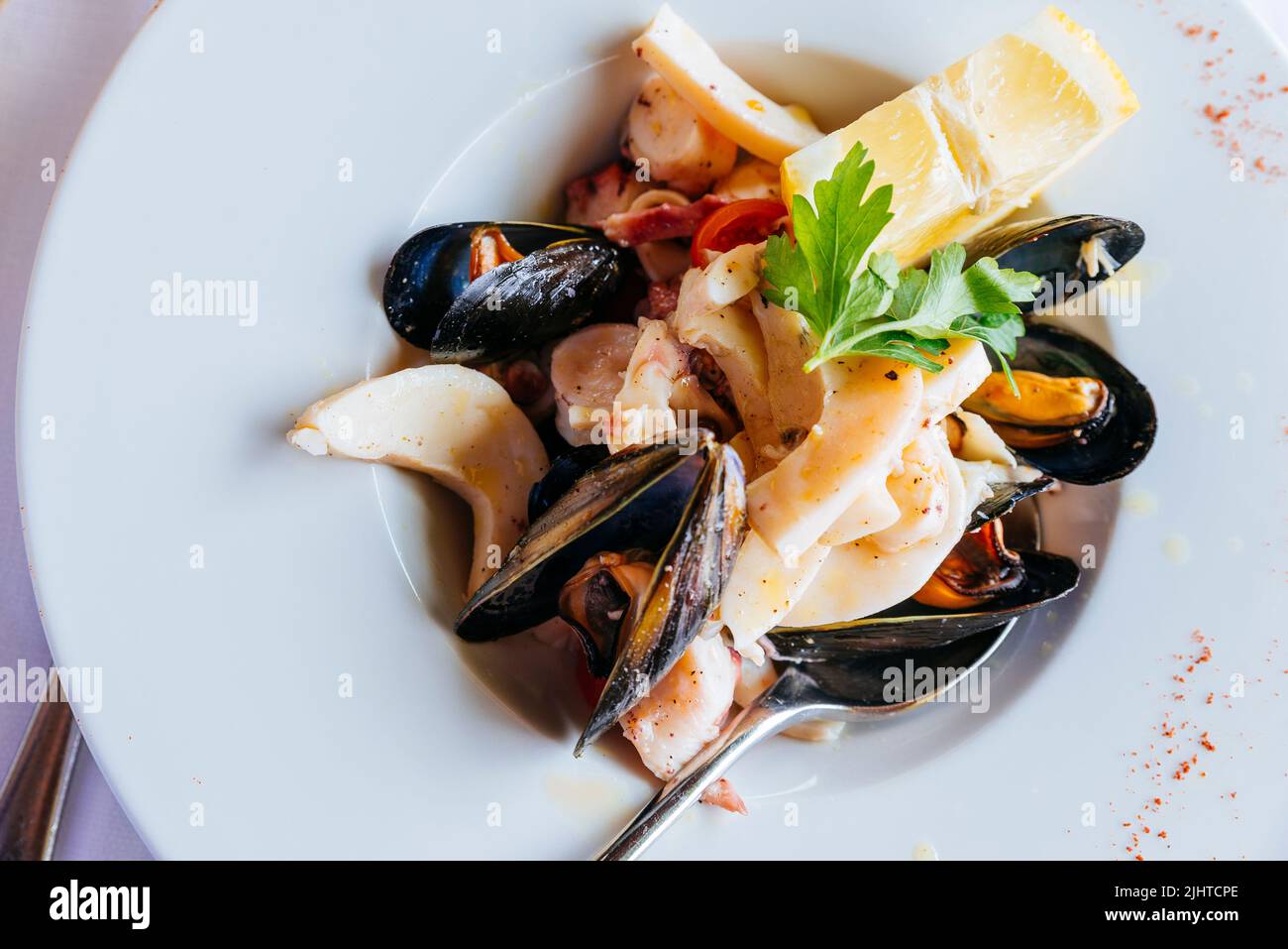 Traditional Italian food. Sea salad with salmoriglio sauce. Bergamo, Lombardy, Italy, Europe Stock Photo