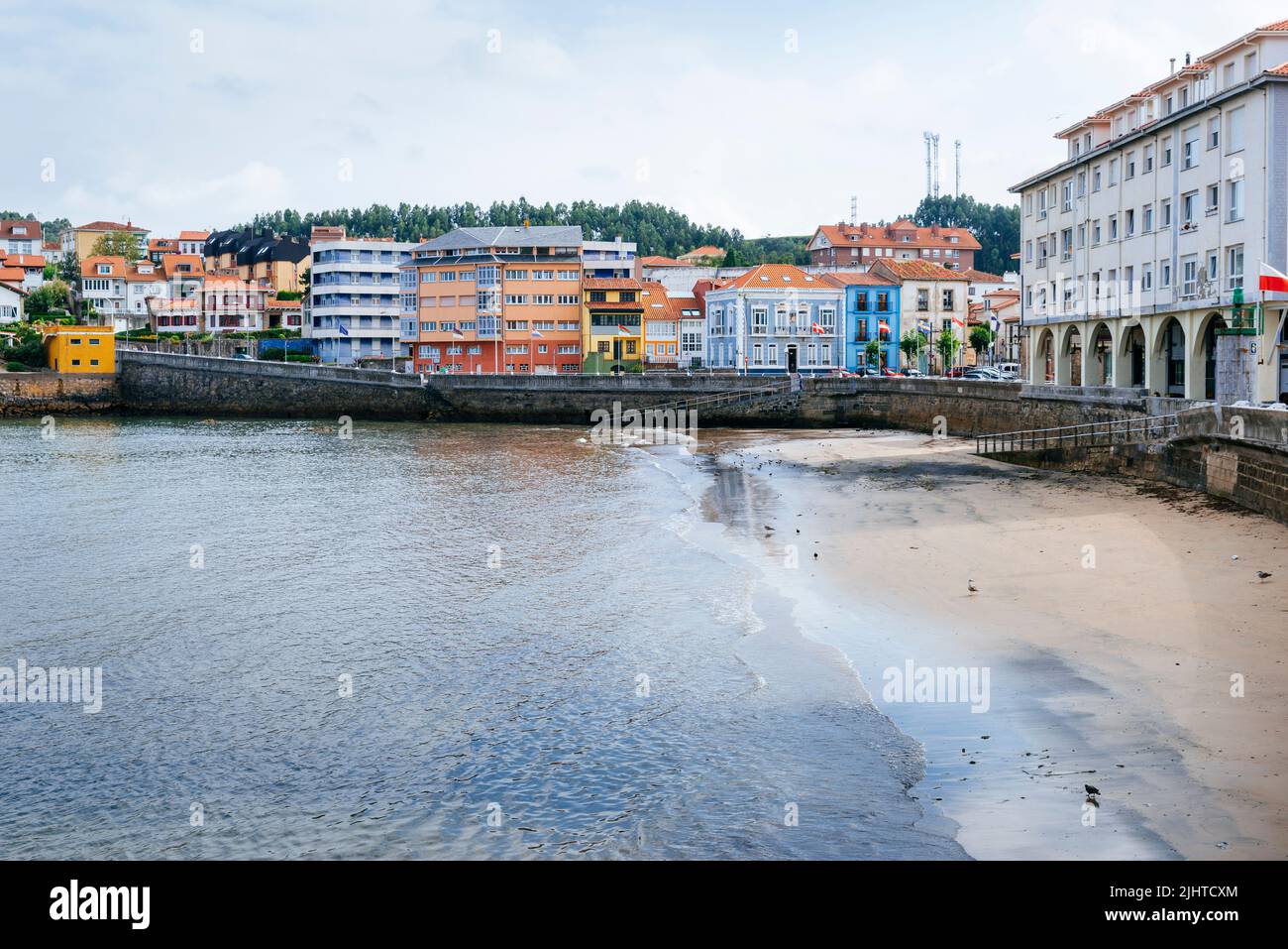 Typical Asturian architecture next to La Ribera Beach. La Ribera Beach does not have a lot of bathers, not even in summer, because it disappears at hi Stock Photo