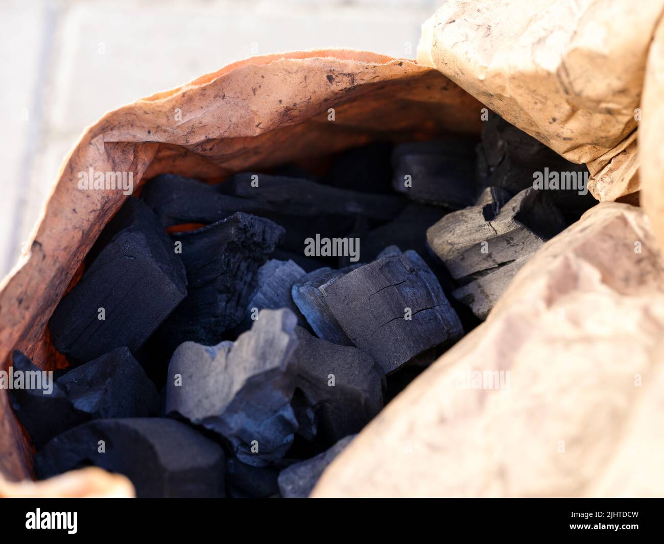 Charcoal pieces in a paper bag. Close-up Stock Photo