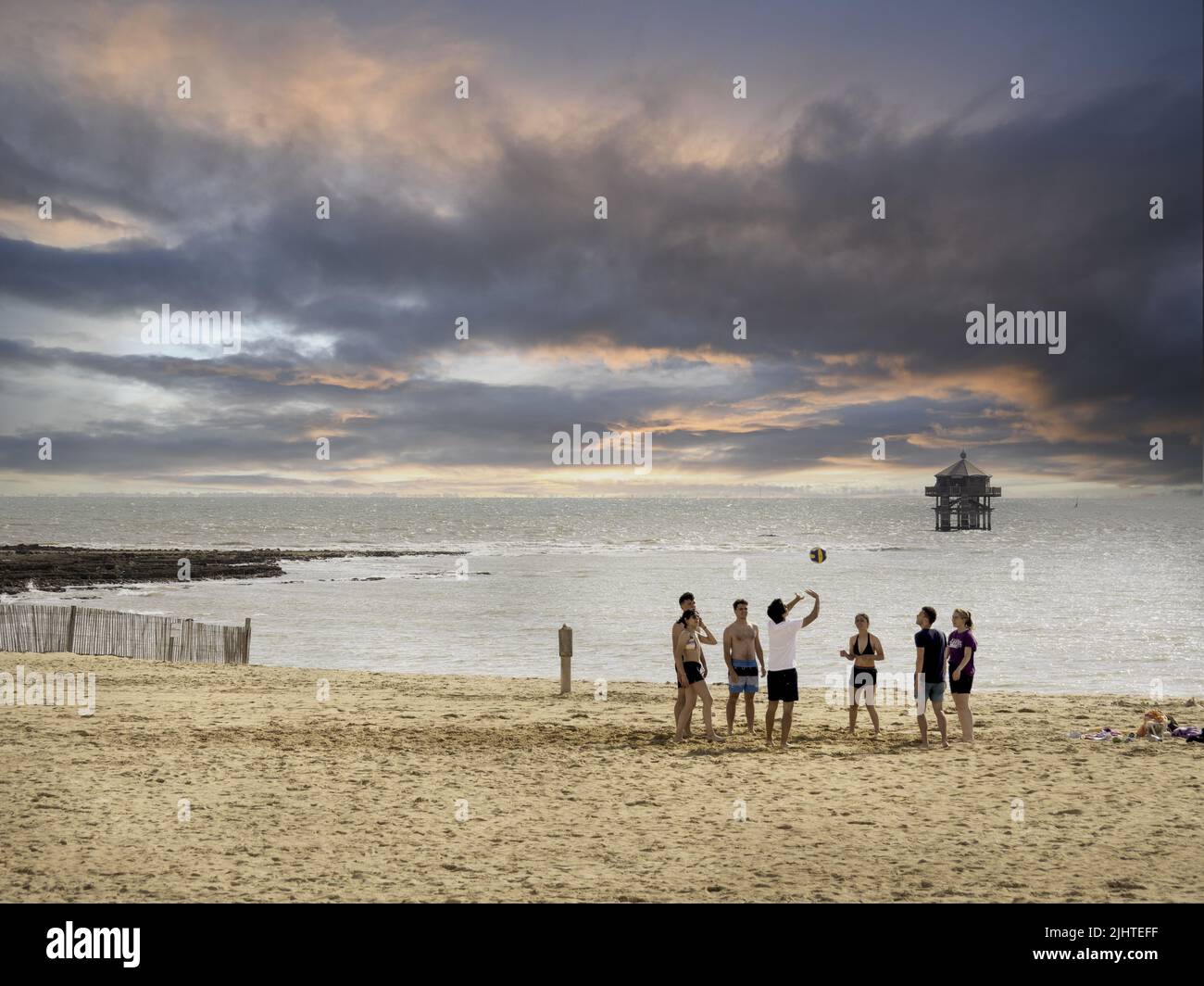 La Rochelle, France July 2022. Beach volleyball - a group of young people playing volleyball on the beach in La Rochelle, smiles on their faces, relax Stock Photo