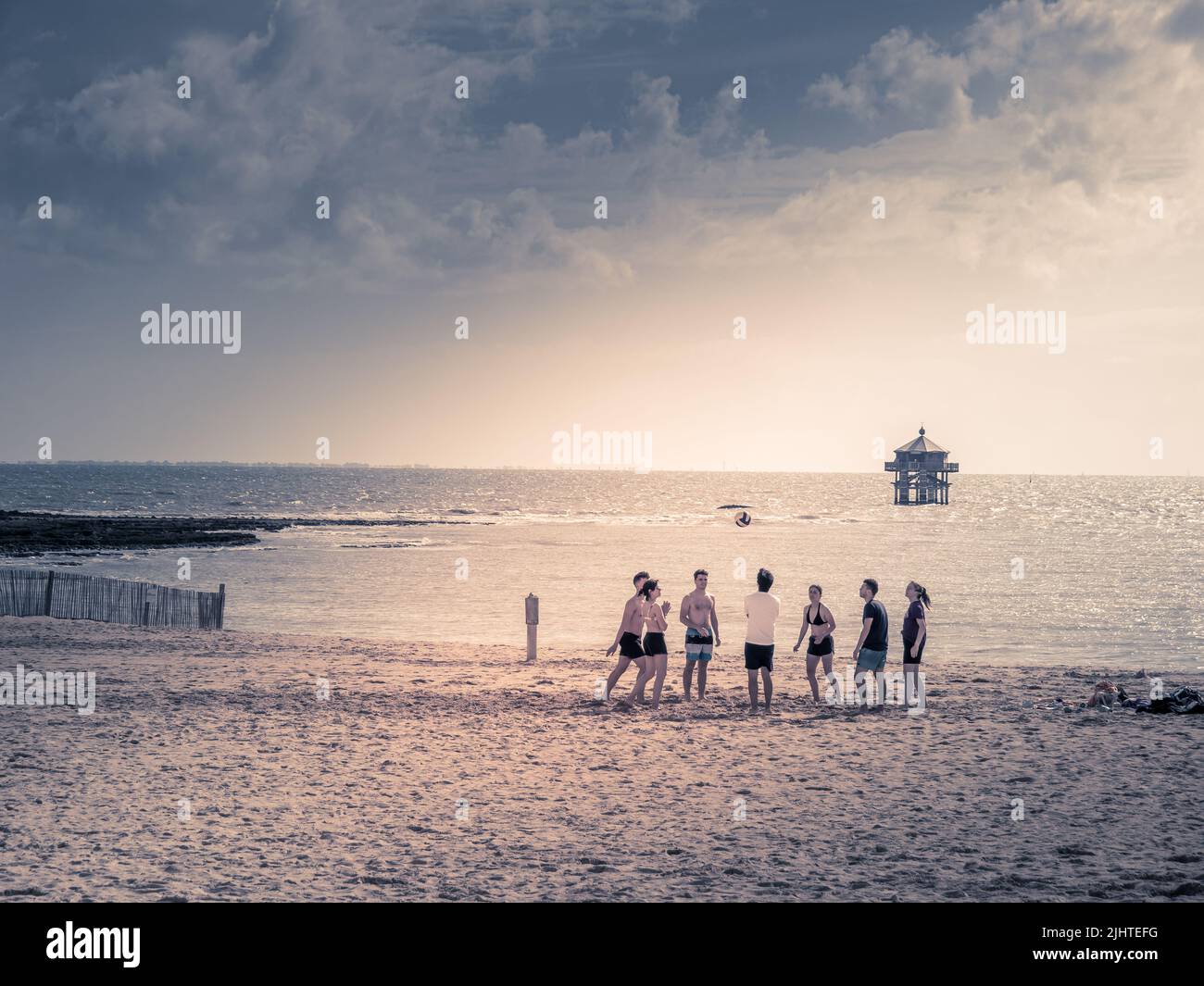 La Rochelle, France July 2022. Beach volleyball - a group of young people playing volleyball on the beach in La Rochelle, smiles on their faces, relax Stock Photo