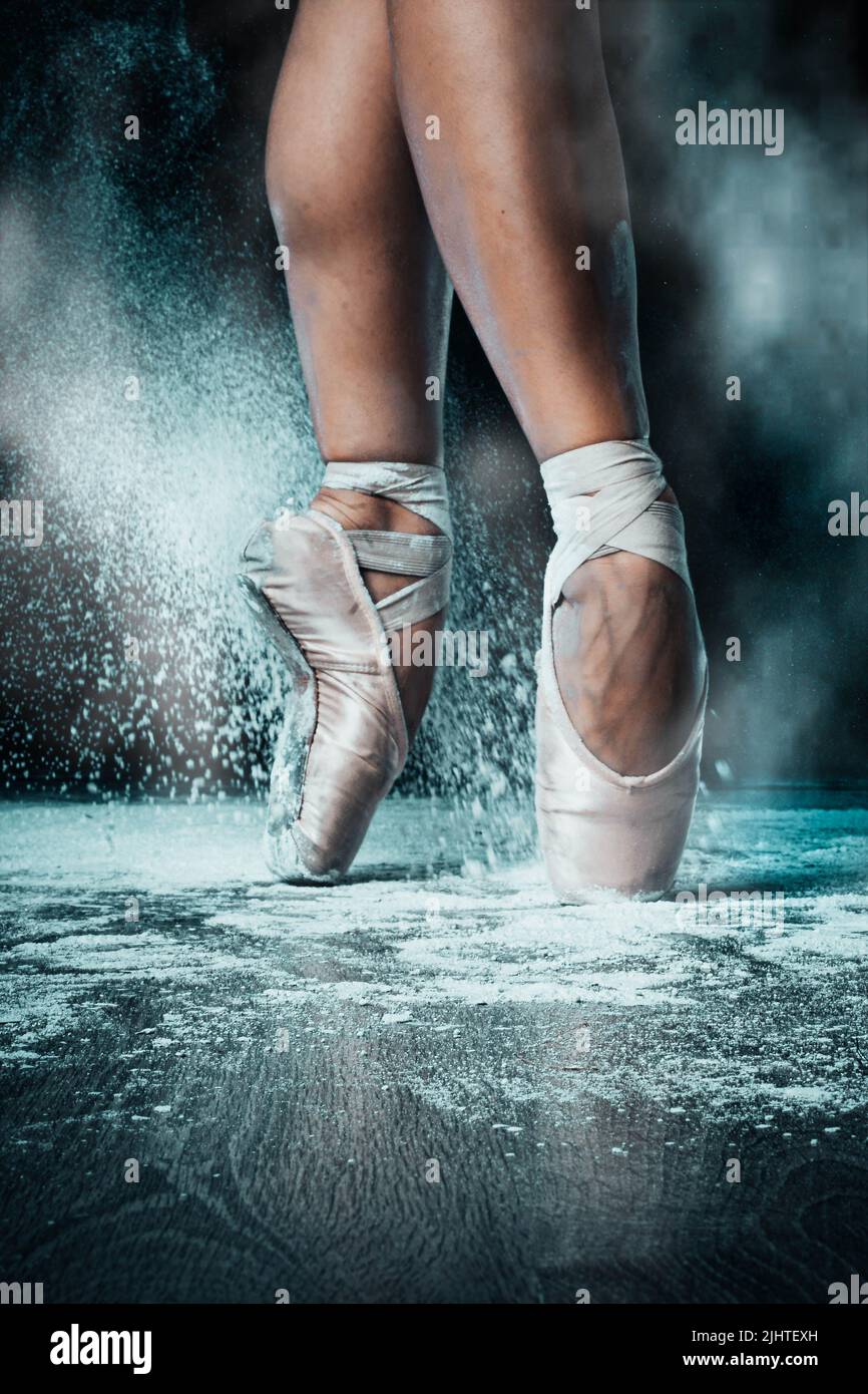 Closeup of ballerina feet in pointe shoes on stage with chalk Stock Photo