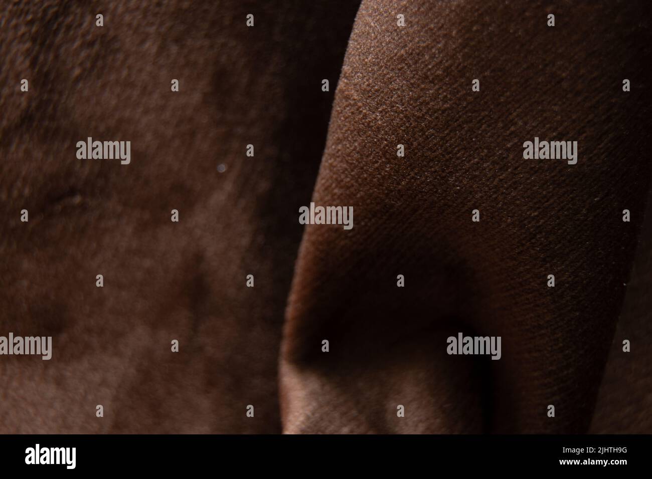 Soft dark brown rumpled fabric macro photo, fabrics on the example of upholstered furniture Stock Photo