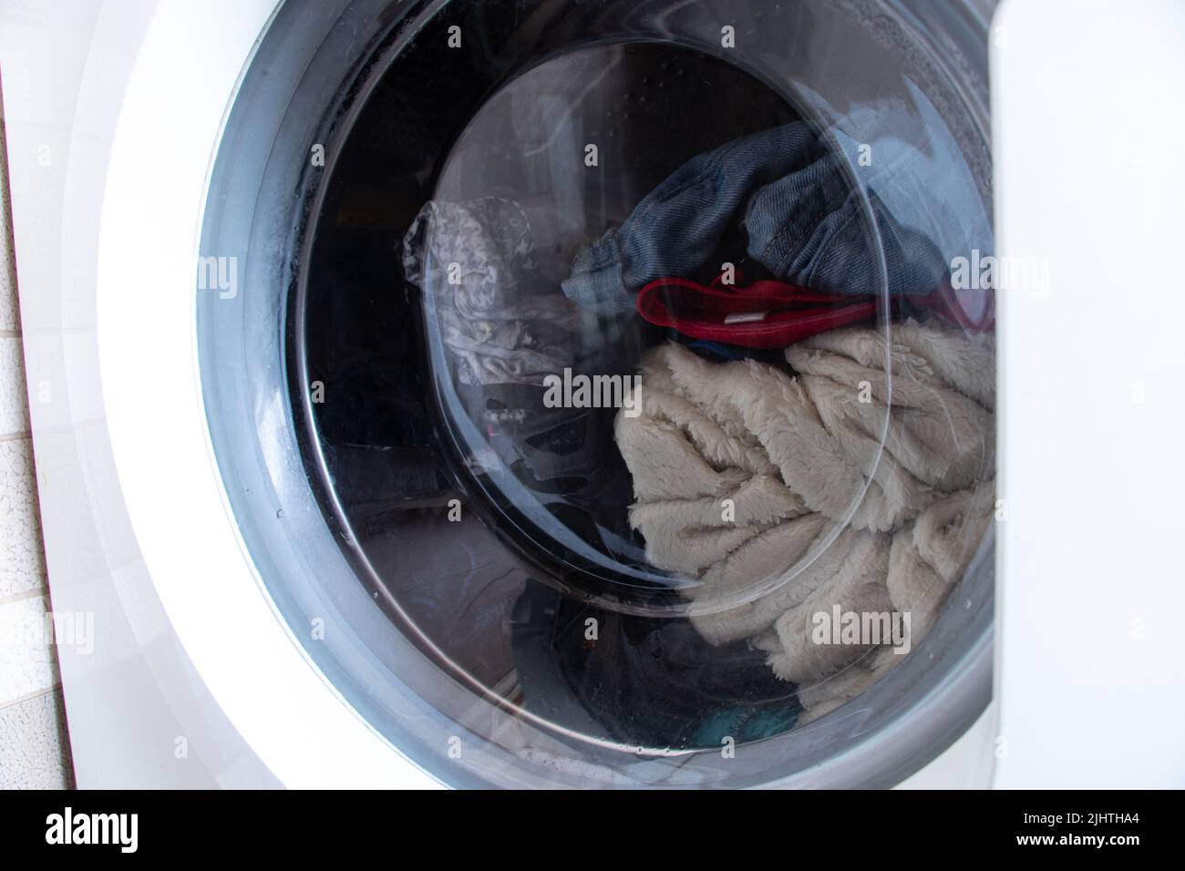 dirty old washing machine with things, washing clothes in a washing