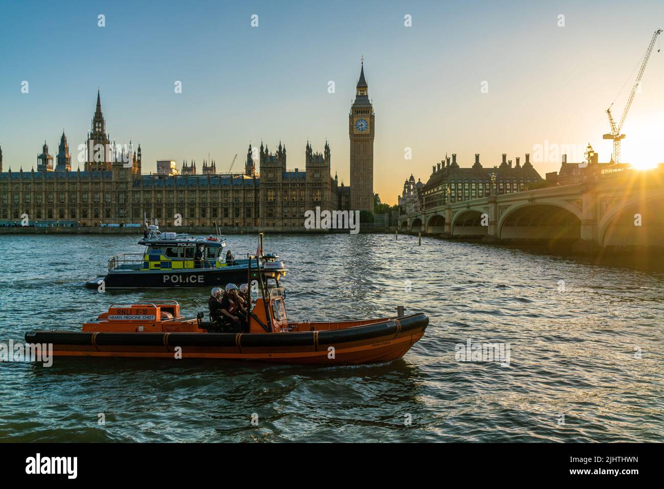THE HOUSES OF PARLIAMENT, LONDON, ENGLAND, JUNE 22, 2022. Police and RNLI Rescue boats on The River Thames by Big Ben, The Houses of Parliament and We Stock Photo