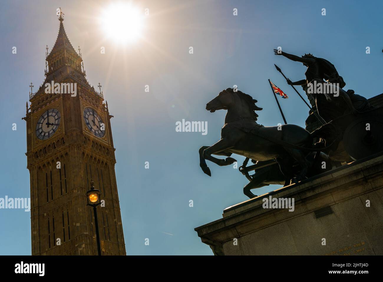 Big Ben, Houses of Parliament and a Union Jack flag flying behind the famous Boadicea or Boudica statue on Westminster Bridge, London, England Stock Photo