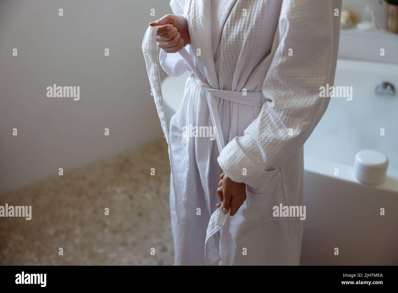 Close up of Caucasian female in gown after taking bath in spa. Bathroom