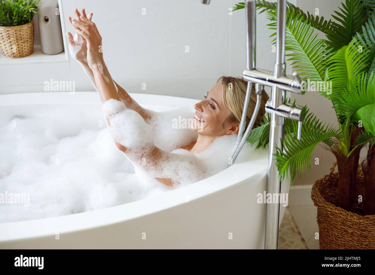 Woman taking relaxing bath Stock Photo by ©belchonock 138135236