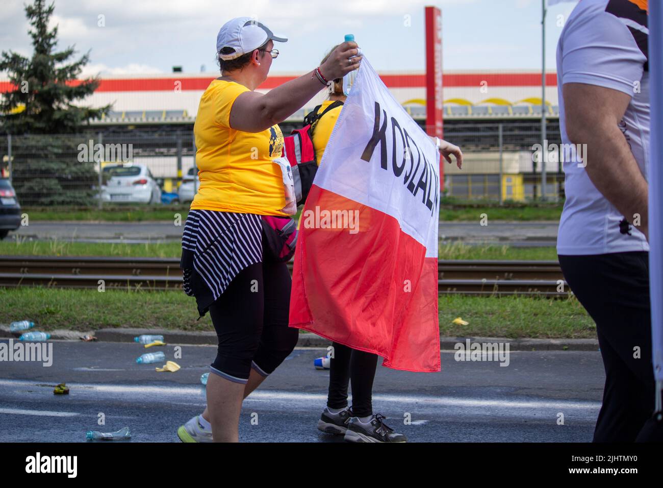 A group of people in yellow shirts holding the Polish flag at Wings for