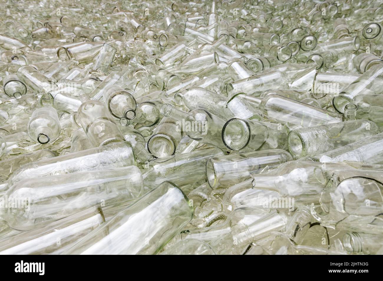 Large pile of broken and whole large glass bottles in preparation for recycling Stock Photo
