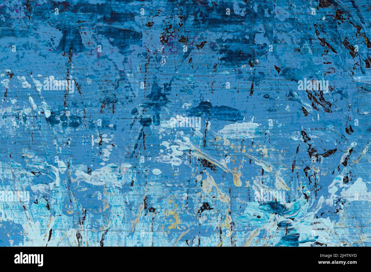 Macro close-up of an abstract blue, white and black acrylic paint background. High resolution full frame textured messy canvas background. Stock Photo