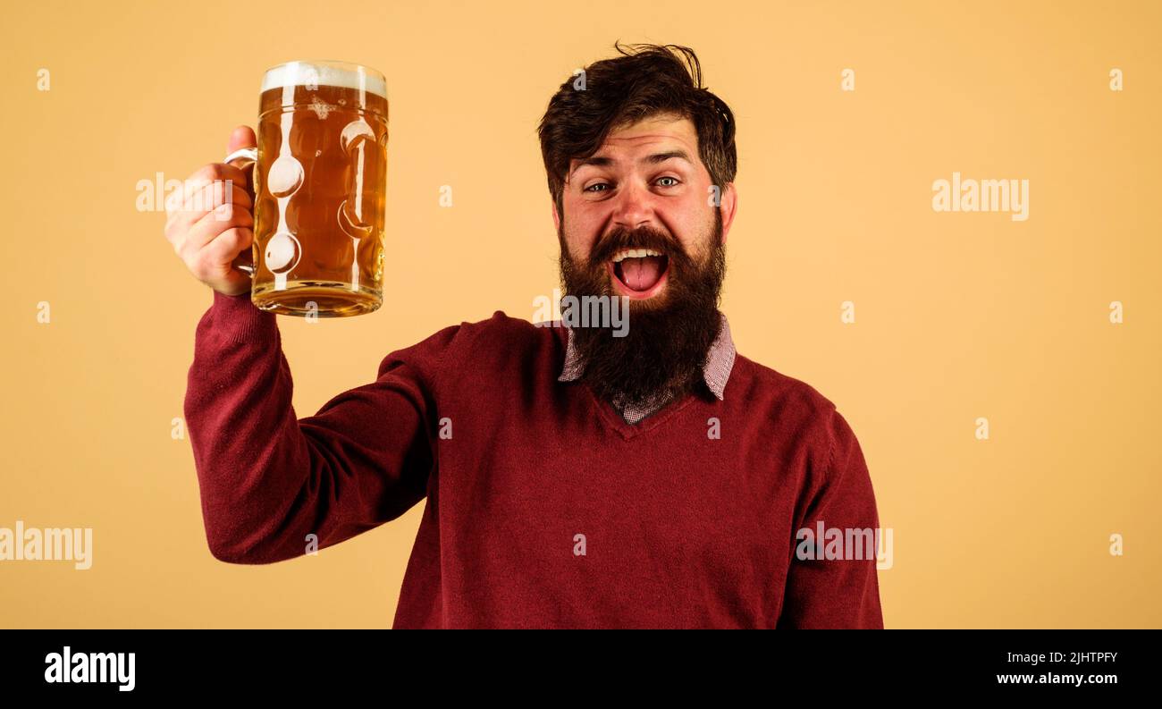 Oktoberfest festival. Happy man with glass of craft beer at pub. Bearded hipster with mug of ale. Stock Photo