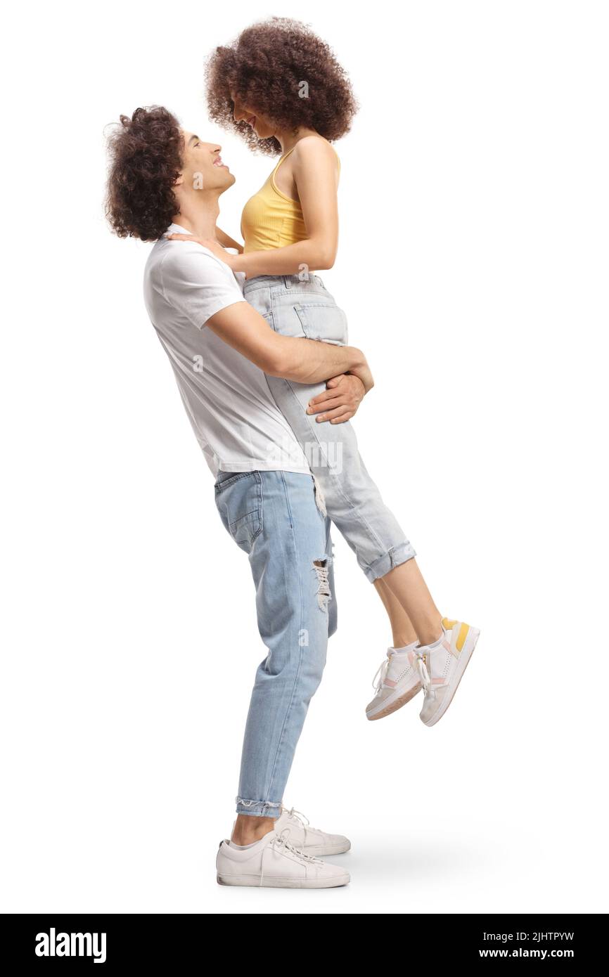 Full length profile shot of a boyfriend holding girlfriend in his hands isolated on white background Stock Photo