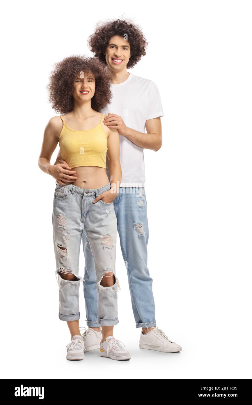 Full length portrait of a young man and woman with curly hair smiling and posing isolated on white background Stock Photo
