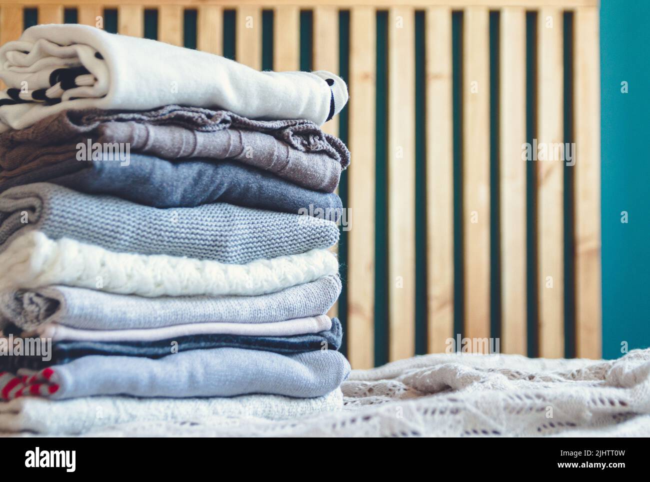 A stack of cozy warm winter clothes lies on the bed Stock Photo - Alamy