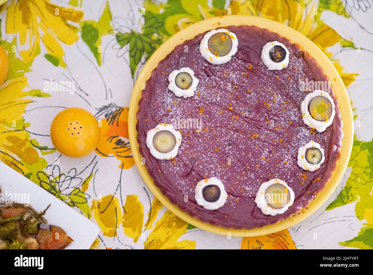 Purple sweet potato pie in a yellow, floral 1970s tablescape. Stock Photo