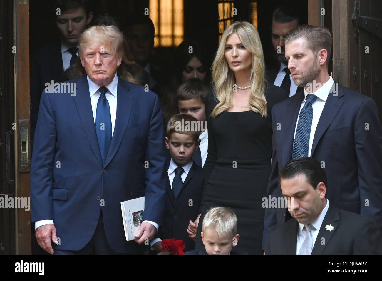 Former President Donald Trump (l), Ivanka Trump (3-r), Donald Trump Jr.  (2-r) and Eric Trump (r) and members of the family stand at the top of the  stairs of St. Vincent Ferrer