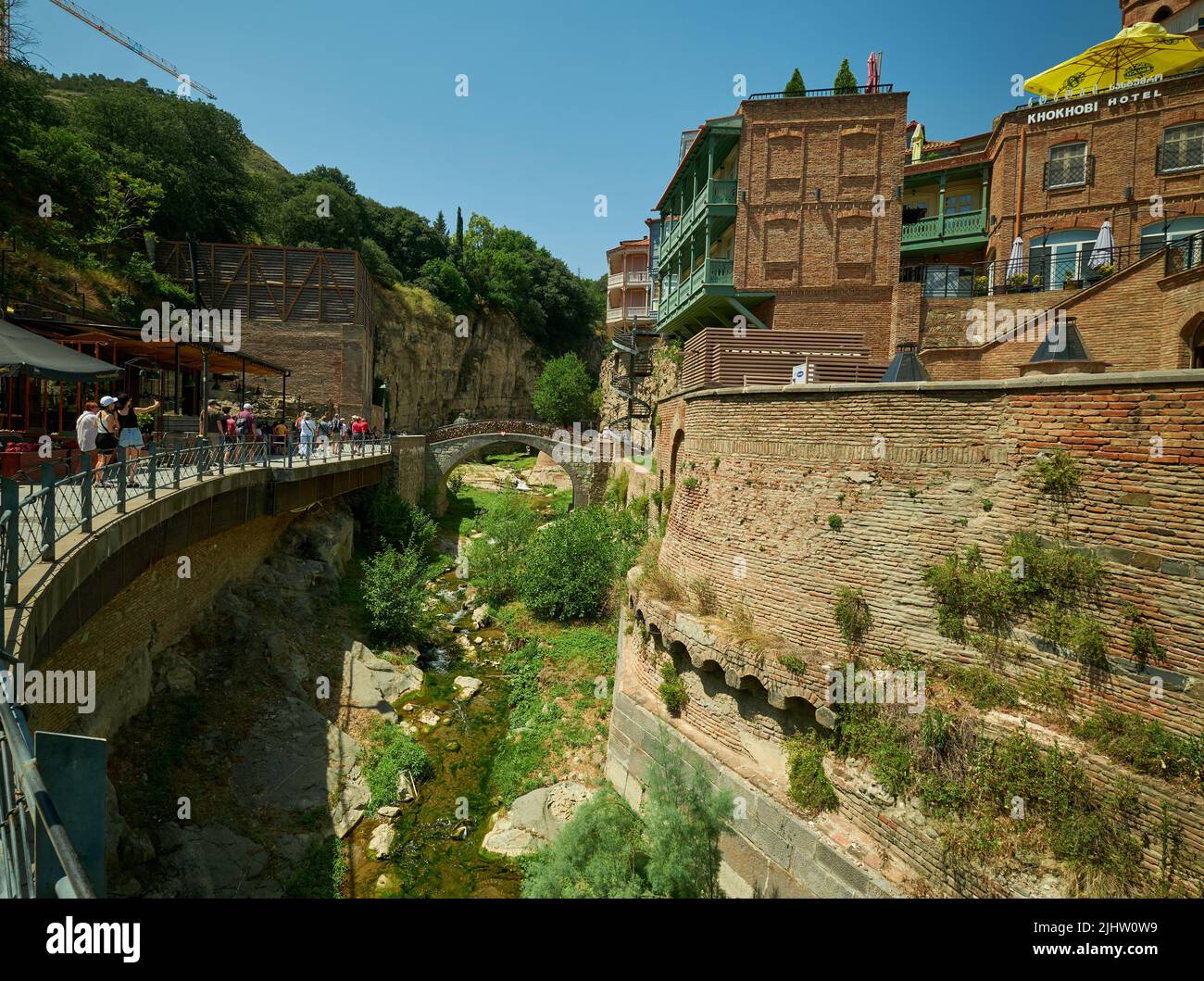 Abanotubani district in Old Tbilisi, Georgia where most of the Sulphur baths are located day light shoot showing bridge of love with visitors walking Stock Photo