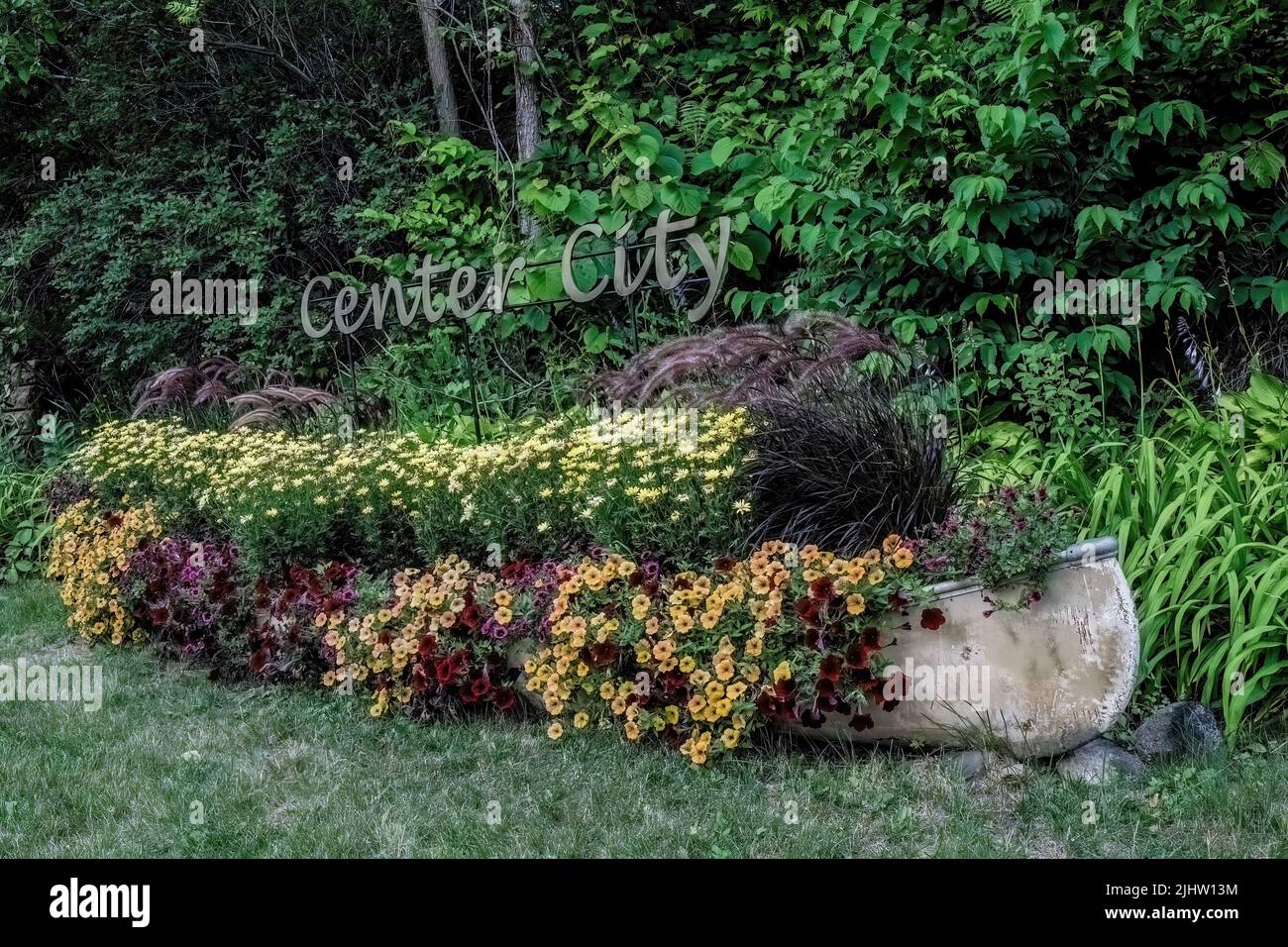Canoe full of blooming summer annuals for the city of Center City, Minnesota USA. Stock Photo