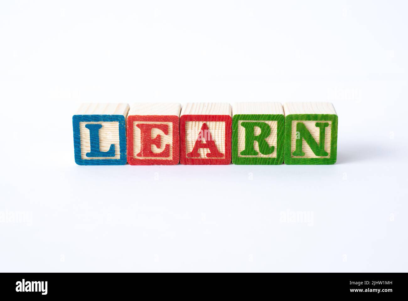 The word Learn spelled with colorful toy blocks on a white background Stock Photo
