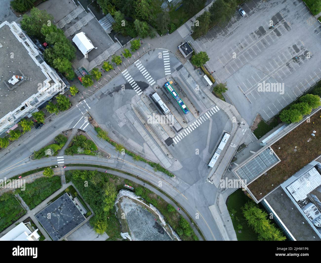 A high-angle shot of a confusing urban street with buildings a parking ...