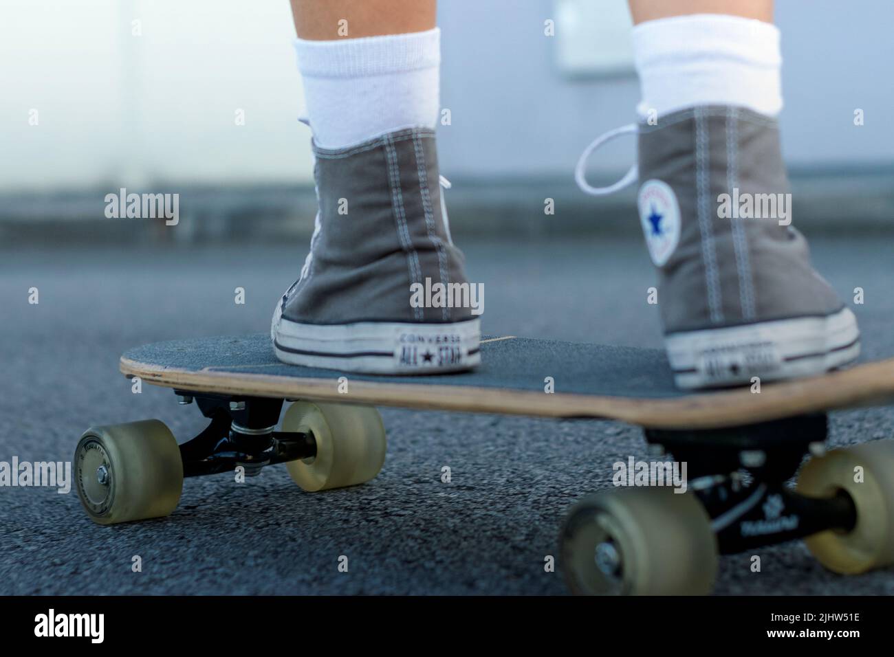 Teenagers lifestyle clothing and skating on the streets, skate motion. Sports trends. Kids playing outdoor, skating in early ages, freestyle skating. Stock Photo