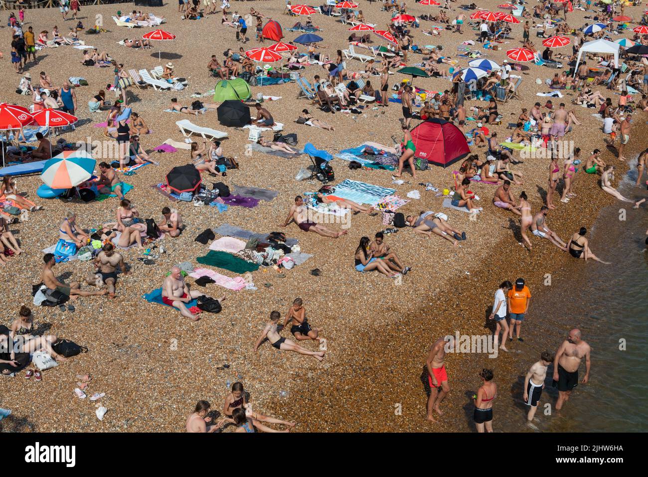 A crowded beach during summer on Brighton seafront Stock Photo