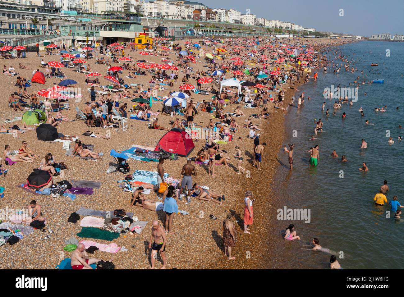 A crowded beach during summer on Brighton seafront Stock Photo