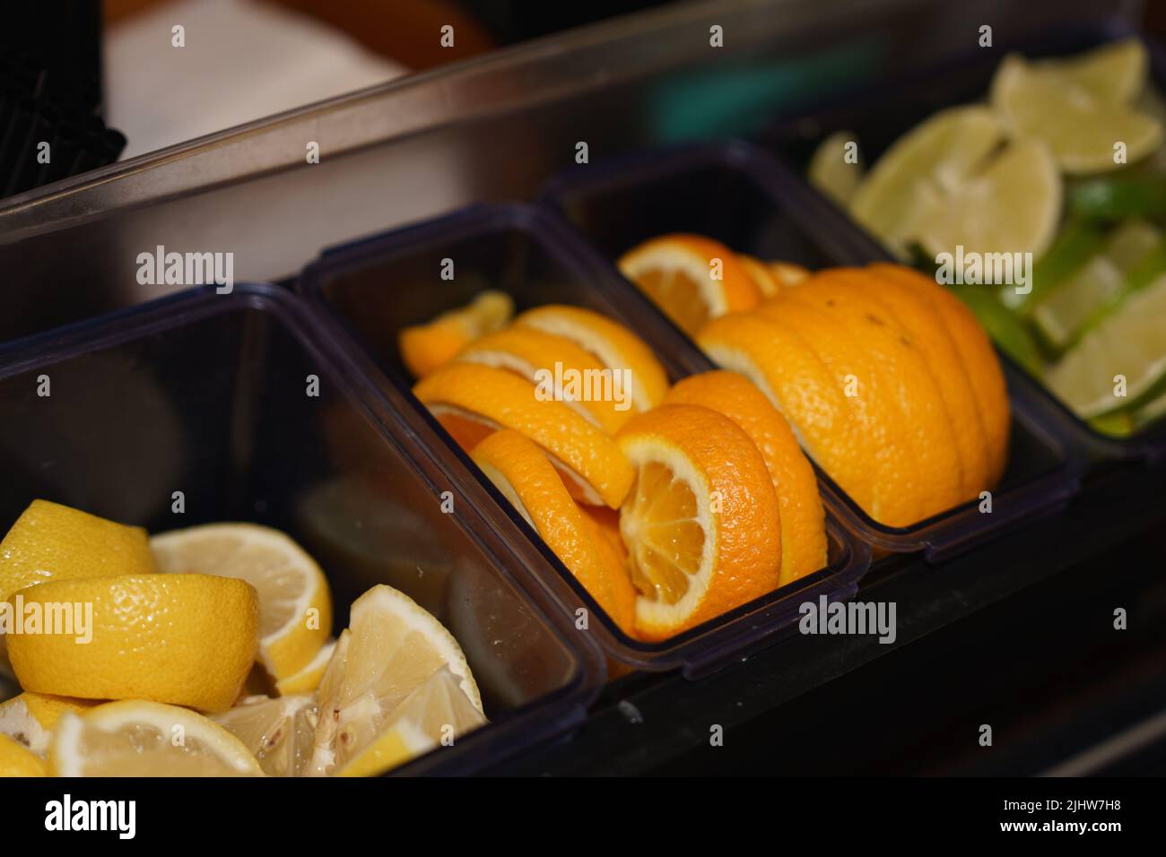 Assorted slices of fruit have been prepared and ready for use as garnishes in mixed adult drinks. Stock Photo
