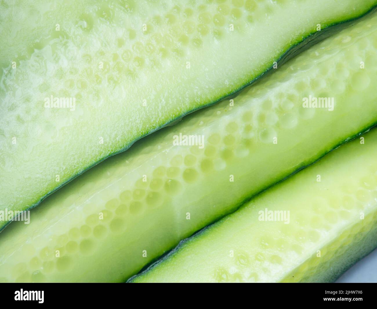 Sliced cucumber on a white background. Vegetable isolate. Healthy diet. Cucumber cut lengthwise