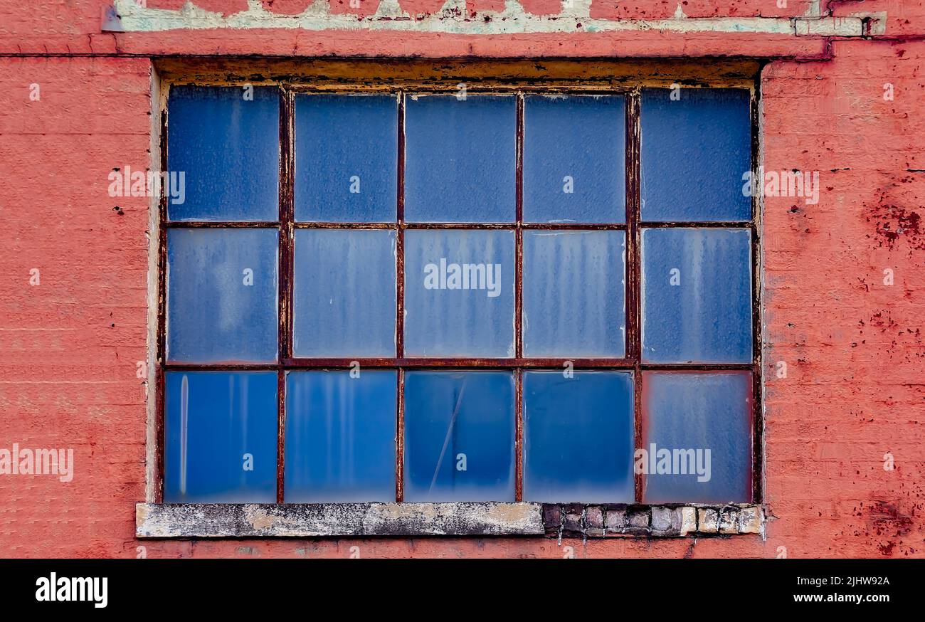 An old window is pictured at the old Mobile County Co-Op, July 17, 2022, in Grand Bay, Alabama. Stock Photo