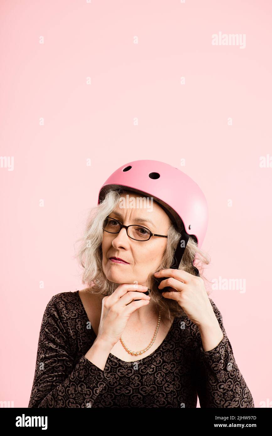 Woman putting on a helmet hi-res stock photography and images - Alamy