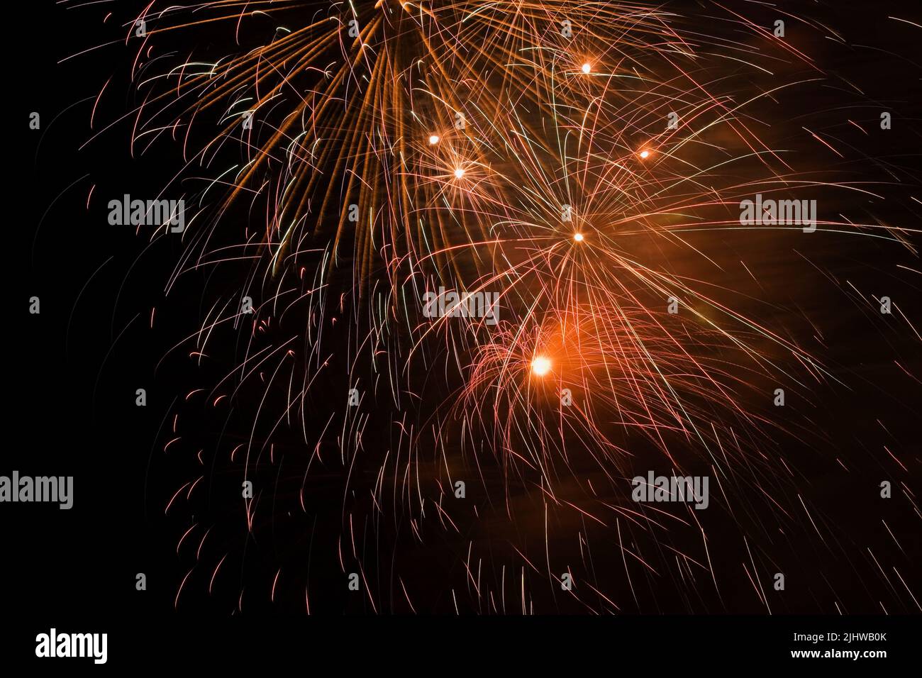 Gold, purple, red, white, yellow and green fireworks in the night sky, Quebec, Canada Stock Photo