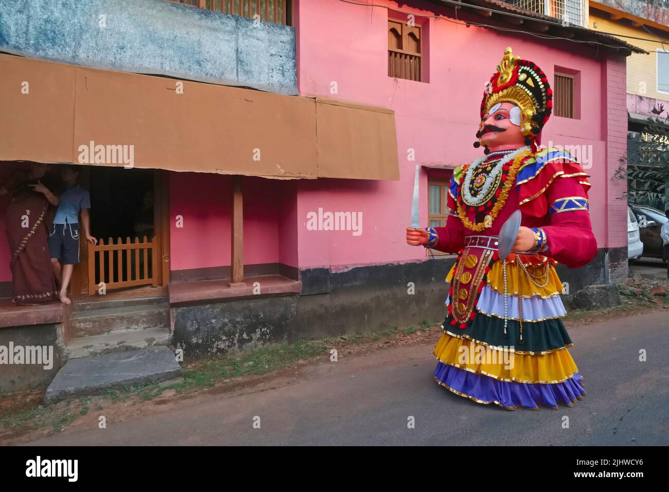 During a festival at Balkrishna Temple in Udipi (Udupi), Karnataka, India, giant warrior puppets moved by a man each inside enliven a procession Stock Photo